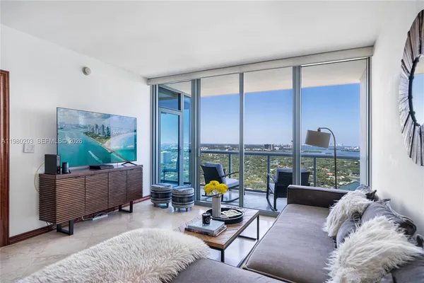 a living room with furniture and large window