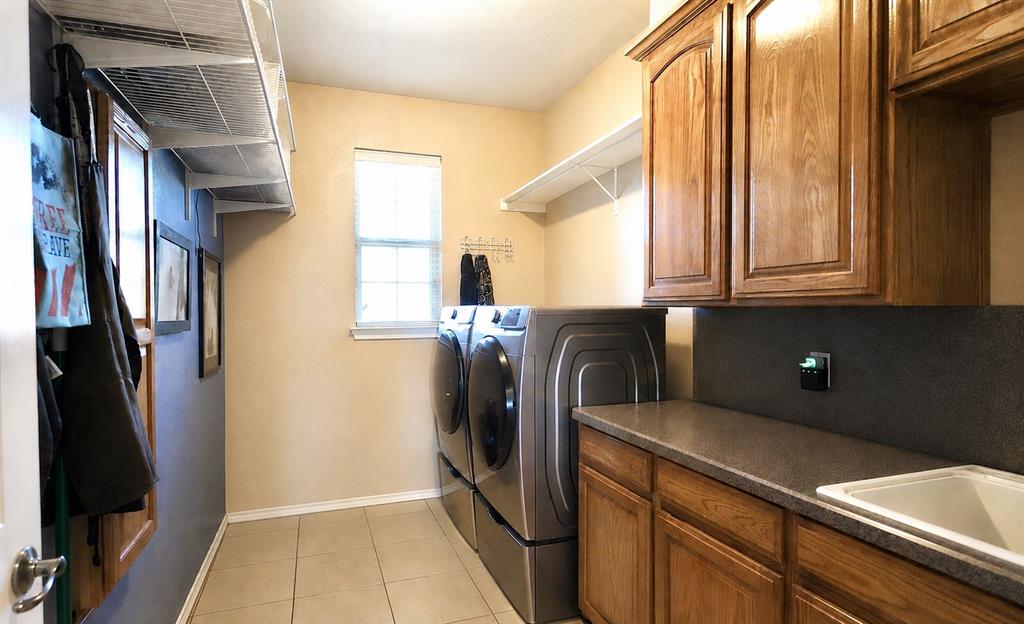 1035 Highland Road Cleburne, TX 76033 - Photo 26 of 36 a kitchen with stainless steel appliances granite countertop a refrigerator and a sink