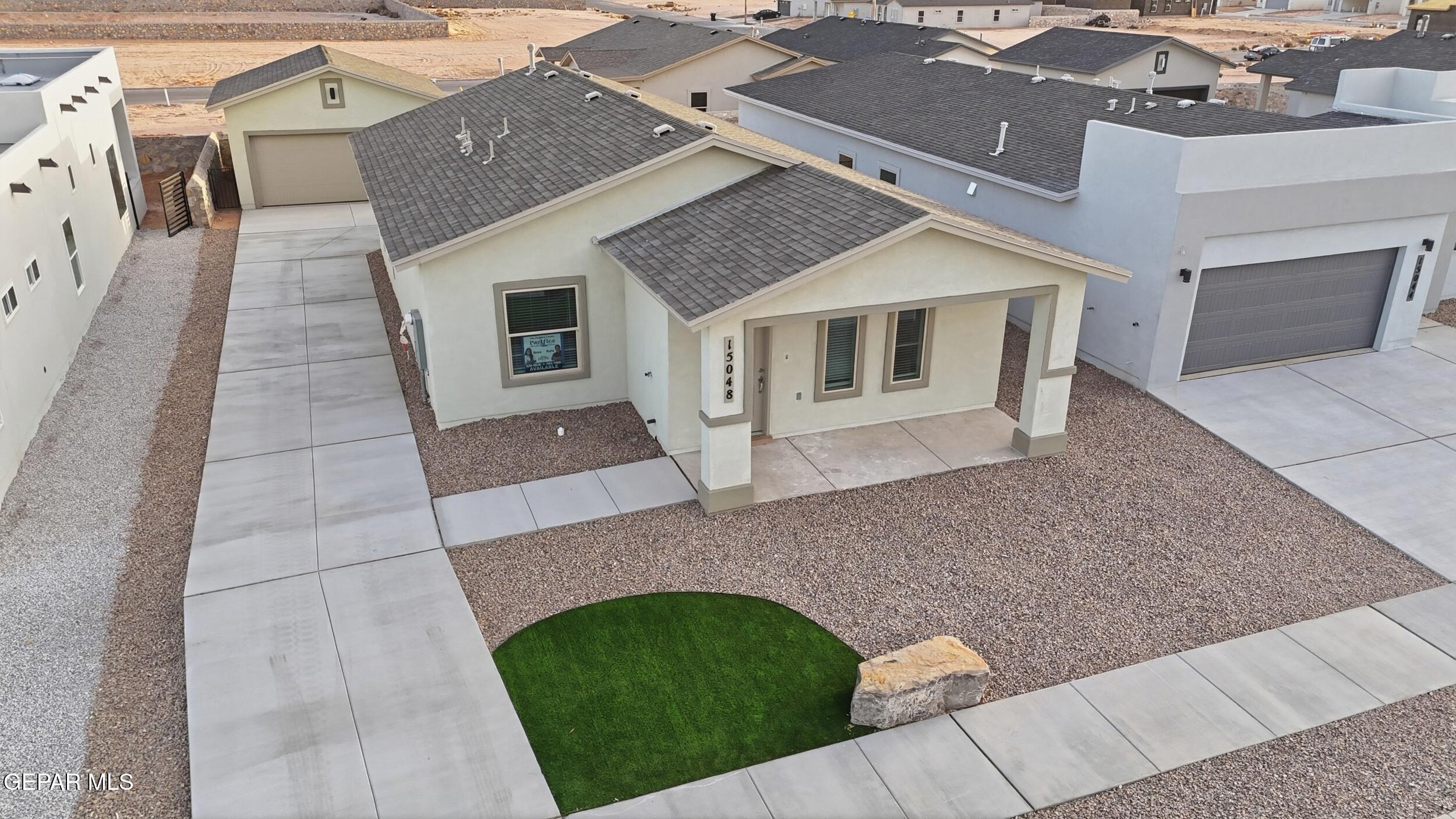 an aerial view of a house with a yard
