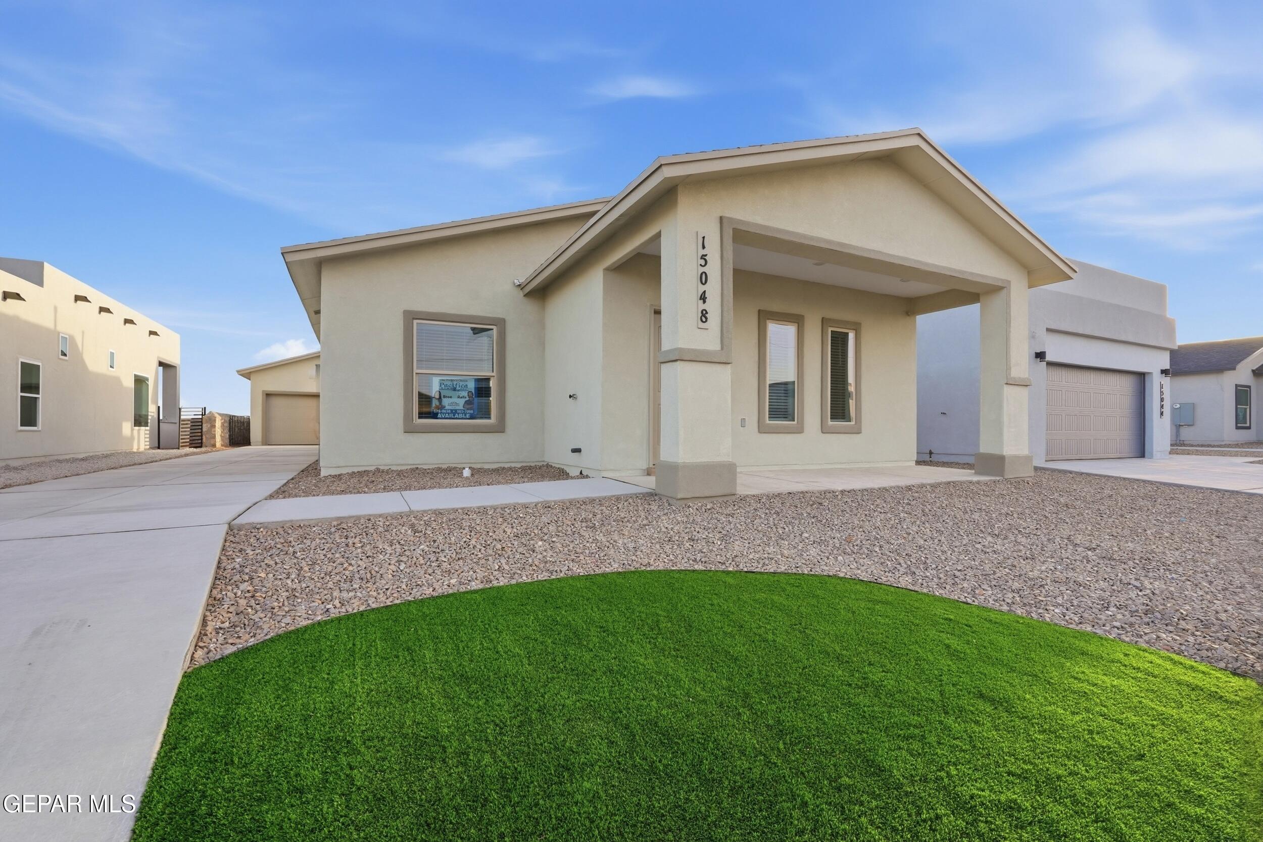3764 Model Lane El Paso, TX 79938 - Photo 2 of 20 a front view of a house with a yard