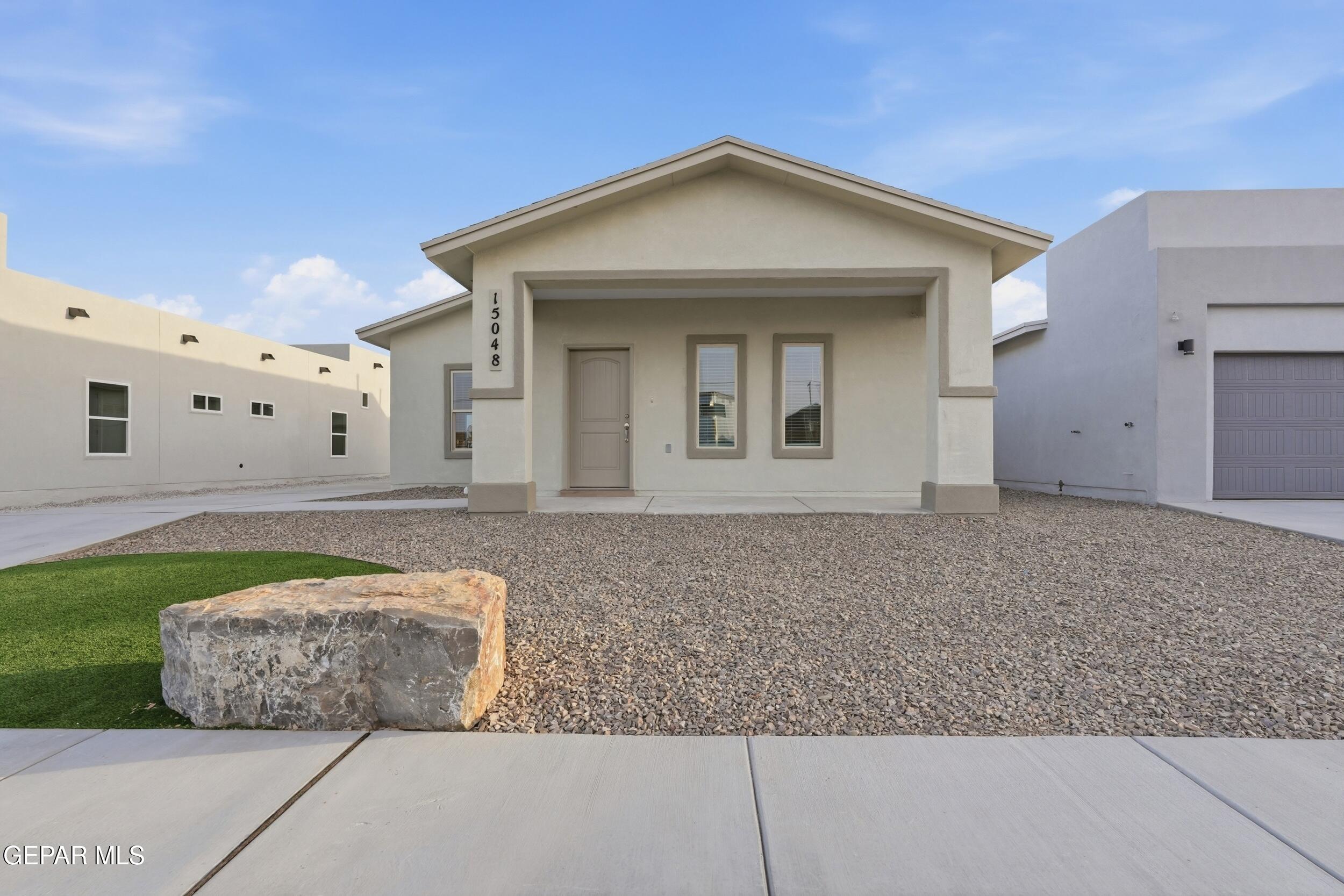 3764 Model Lane El Paso, TX 79938 - Photo 3 of 20 a front view of a house with garden