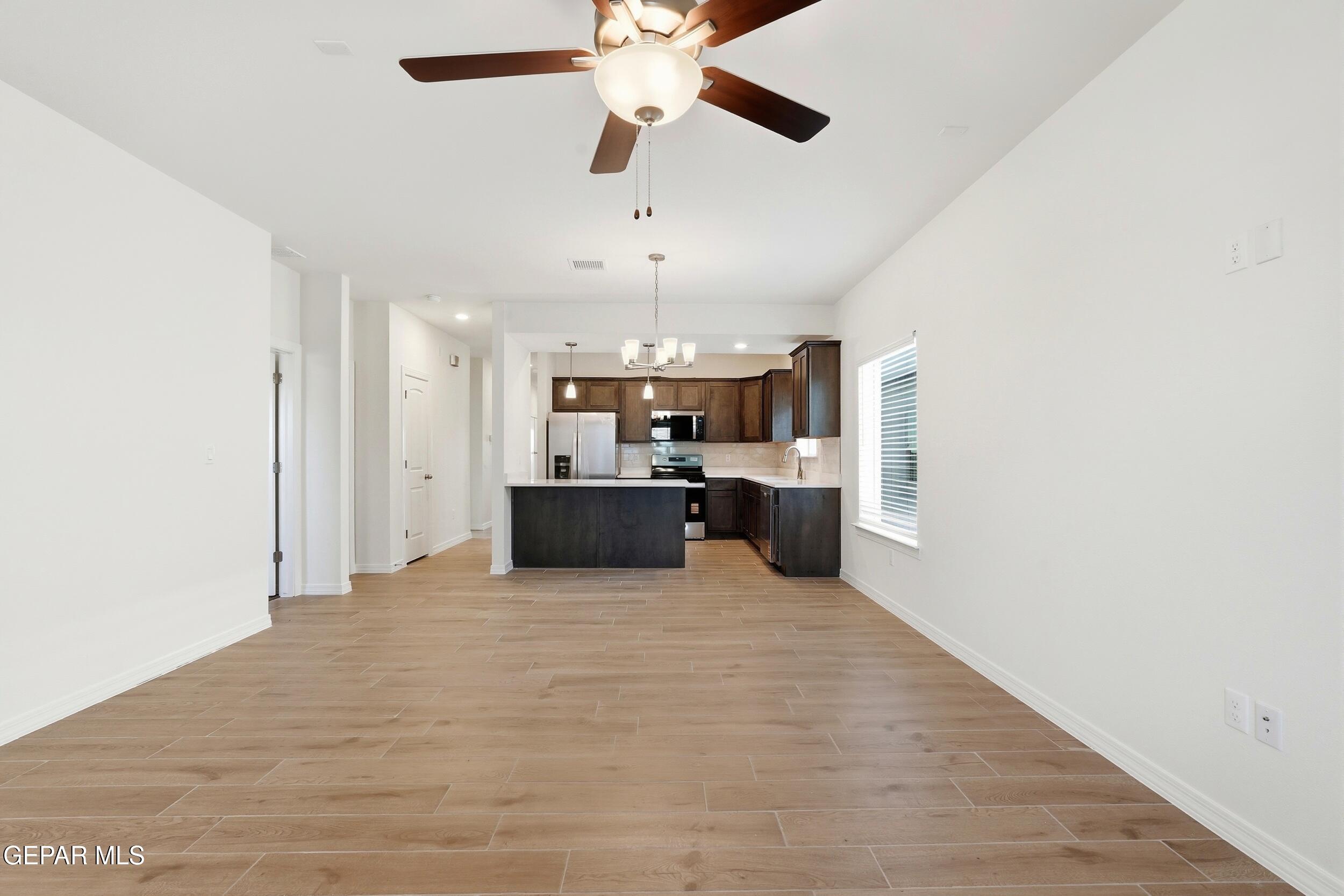 3764 Model Lane El Paso, TX 79938 - Photo 5 of 20 a large white kitchen with a sink and refrigerator