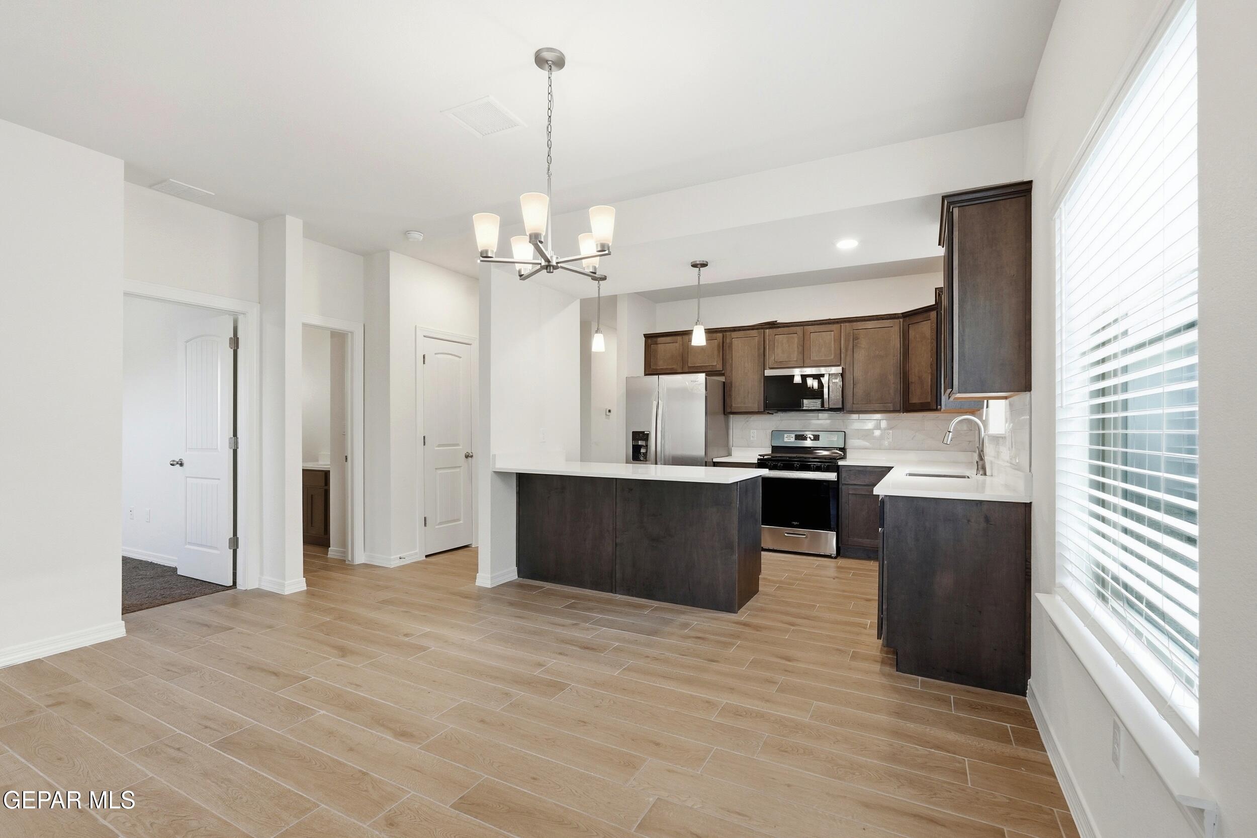 3764 Model Lane El Paso, TX 79938 - Photo 6 of 20 a kitchen with stainless steel appliances kitchen island granite countertop a refrigerator a stove a sink and a oven