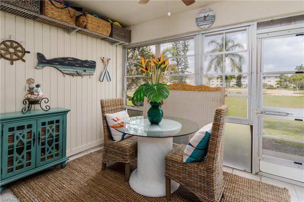 1014 Manatee Road, Unit F102 Naples, FL 34114 - Photo 11 of 36 a dining room with furniture a rug and wooden floor