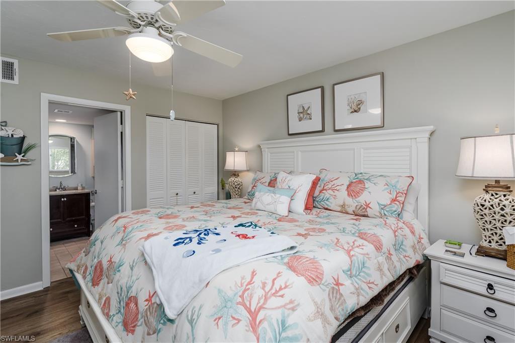 1014 Manatee Road, Unit F102 Naples, FL 34114 - Photo 14 of 36 a bedroom with a bed and a lamp on dresser