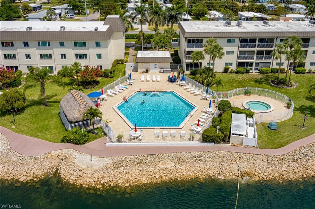 1014 Manatee Road, Unit F102 Naples, FL 34114 - Photo 26 of 36 a front view of a house with a yard and garage
