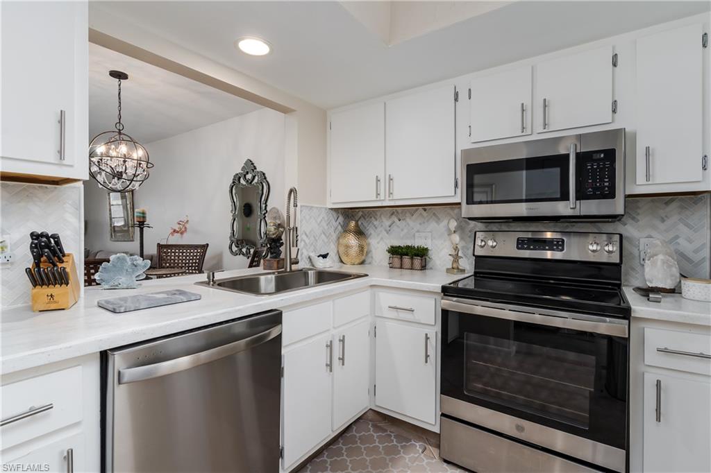 1014 Manatee Road, Unit F102 Naples, FL 34114 - Photo 3 of 36 a kitchen with a sink stove and microwave