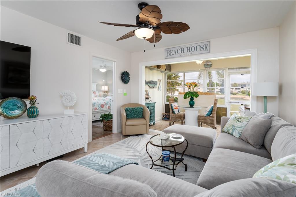 1014 Manatee Road, Unit F102 Naples, FL 34114 - Photo 8 of 36 a living room with furniture ceiling fan and a rug