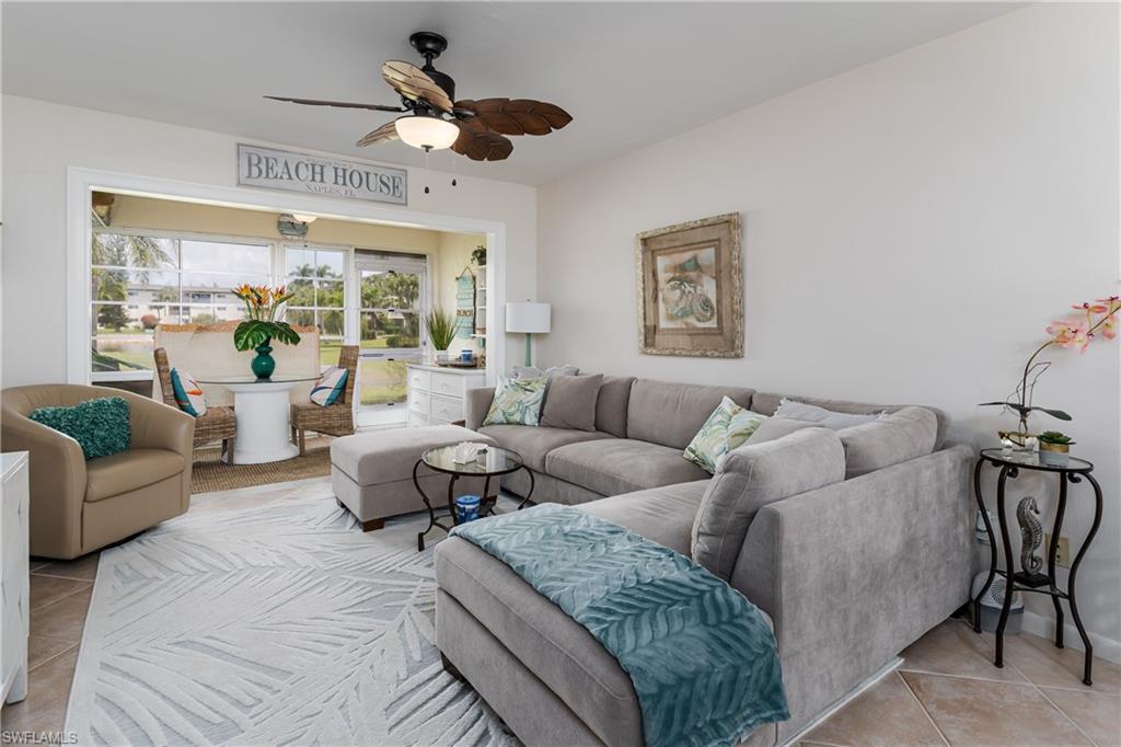 1014 Manatee Road, Unit F102 Naples, FL 34114 - Photo 10 of 36 a living room with furniture ceiling fan and a large window