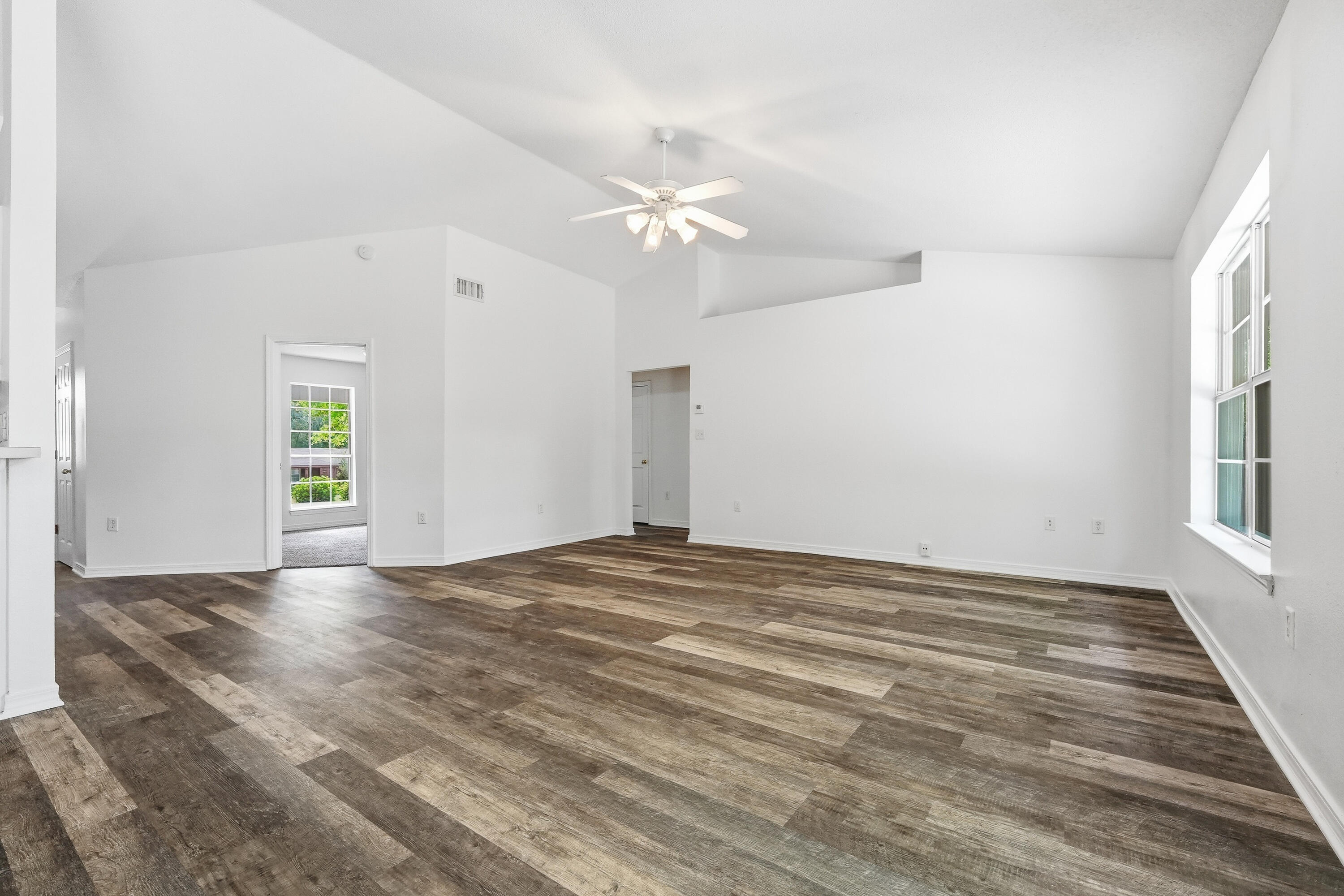 4087 Audiss Road Milton, FL 32583 - Photo 11 of 34 wooden floor in an empty room with a window