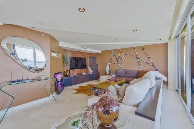 a bathroom with a tub a sink and a large mirror