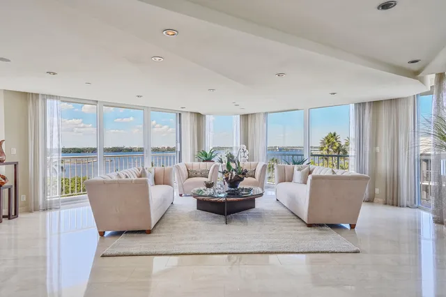 a living room with furniture city view and large windows