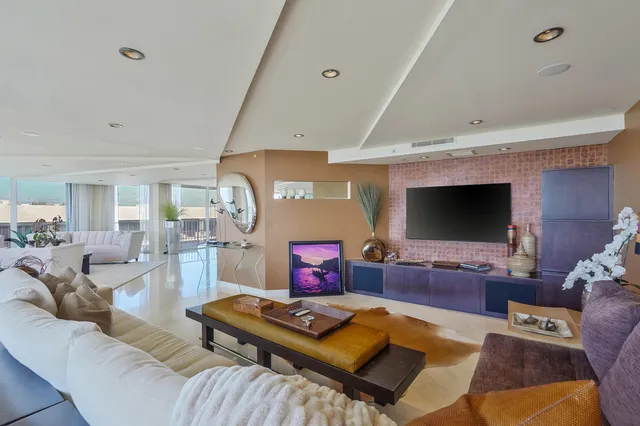 a bathroom with a granite countertop sink a toilet a mirror and shower