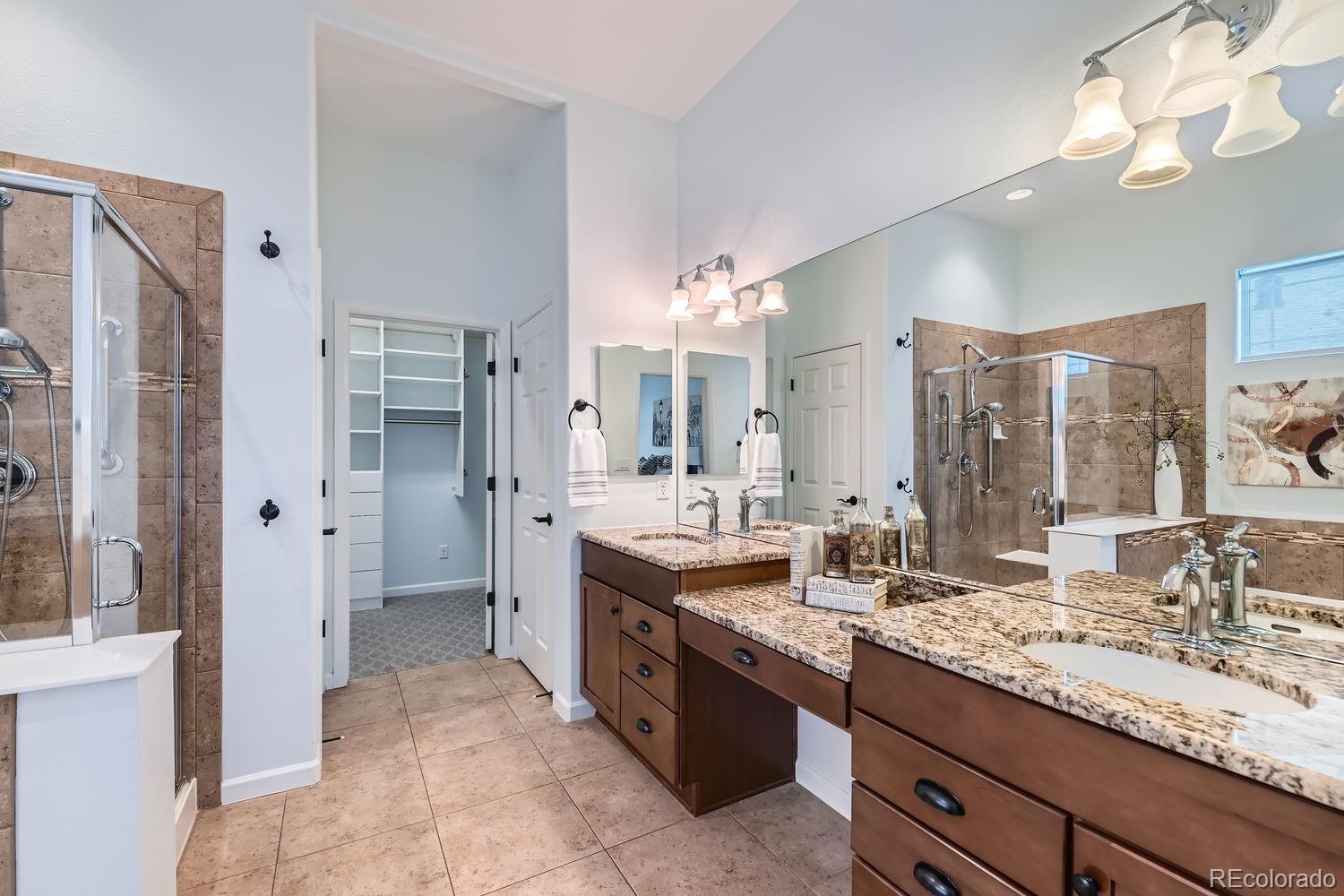 4500 Silver Mountain Loop Broomfield, CO 80023 - Photo 18 of 37 a bathroom with a granite countertop double vanity sink a mirror and shower
