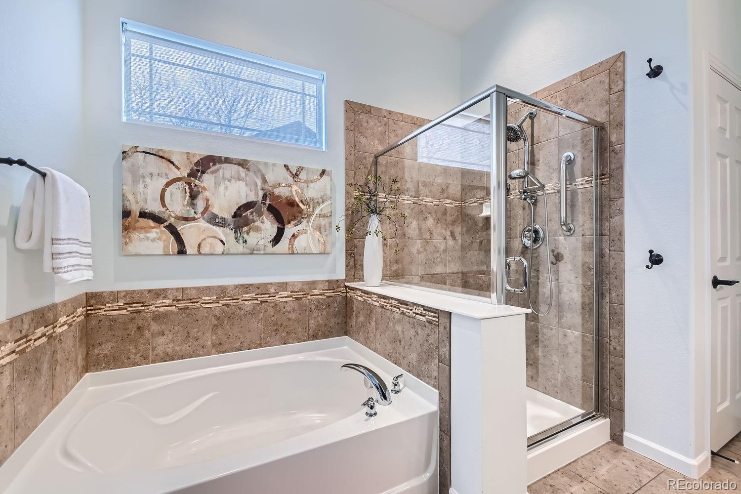 4500 Silver Mountain Loop Broomfield, CO 80023 - Photo 19 of 37 a bathroom with a bathtub and shower