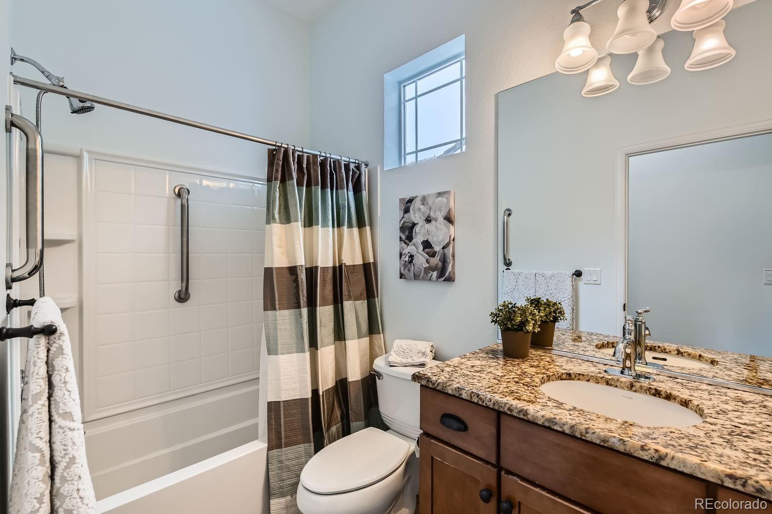 4500 Silver Mountain Loop Broomfield, CO 80023 - Photo 23 of 37 a bathroom with a granite countertop sink toilet and shower