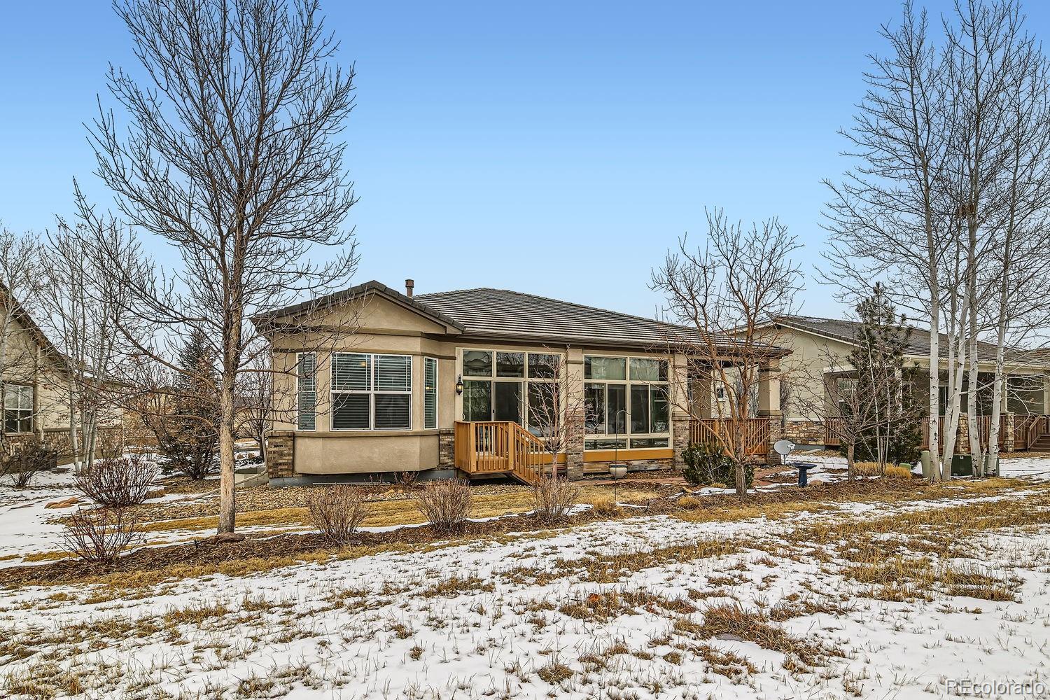 4500 Silver Mountain Loop Broomfield, CO 80023 - Photo 27 of 37 a front view of a house with a yard covered in snow
