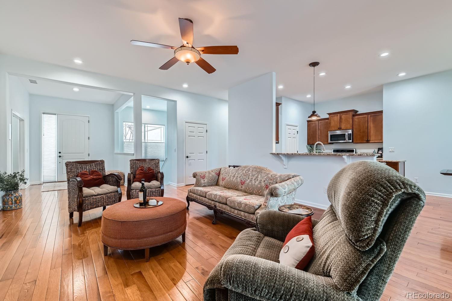 4500 Silver Mountain Loop Broomfield, CO 80023 - Photo 7 of 37 a living room with furniture and a wooden floor