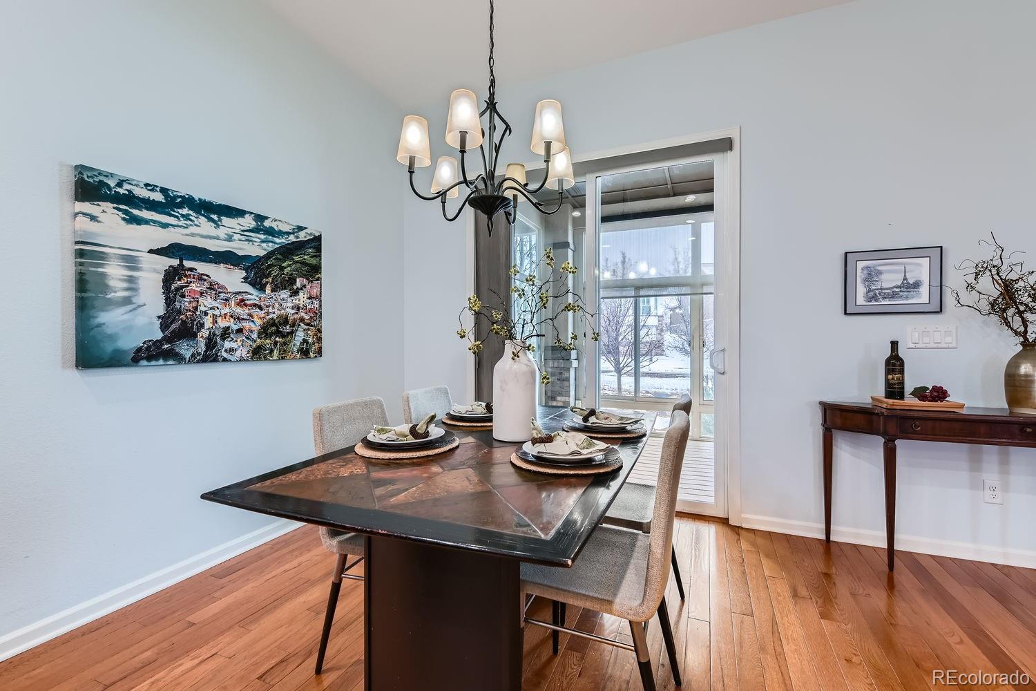 4500 Silver Mountain Loop Broomfield, CO 80023 - Photo 8 of 37 a view of a dining room with furniture wooden floor and chandelier