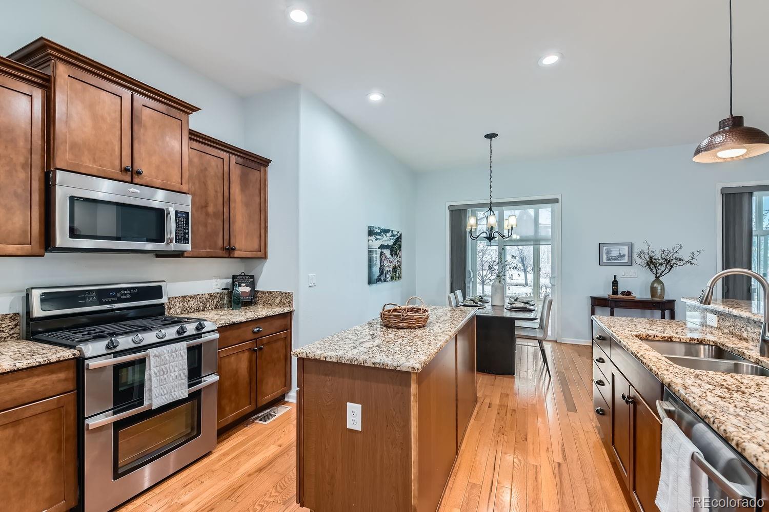 4500 Silver Mountain Loop Broomfield, CO 80023 - Photo 9 of 37 a kitchen with stainless steel appliances a stove sink microwave and cabinets