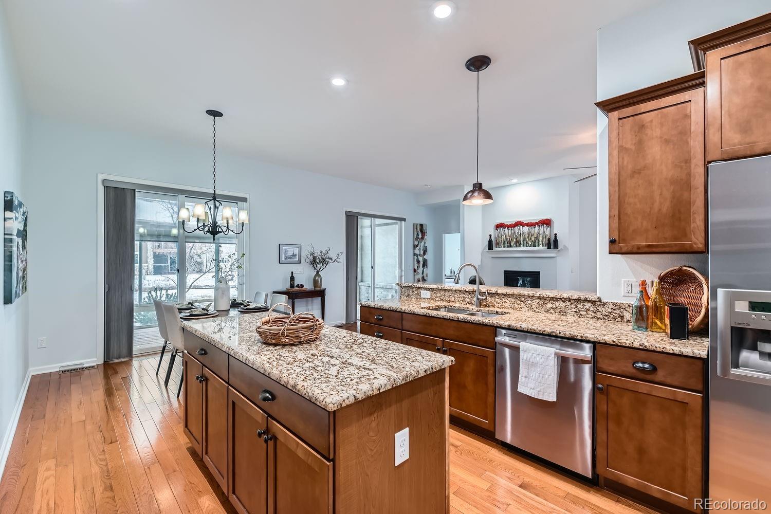 4500 Silver Mountain Loop Broomfield, CO 80023 - Photo 10 of 37 a kitchen with kitchen island granite countertop a sink and a stove
