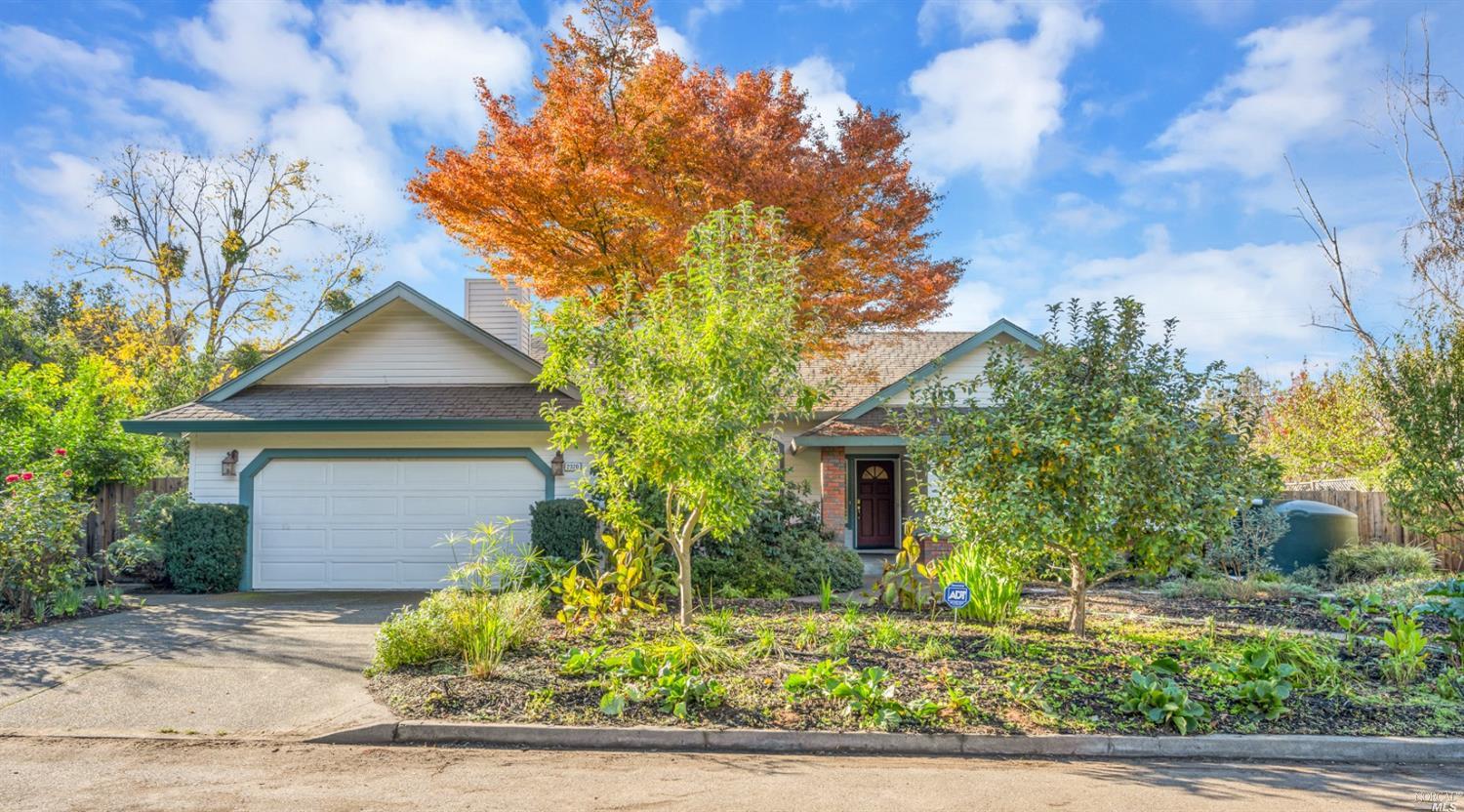 a front view of a house with a yard garage and outdoor seating
