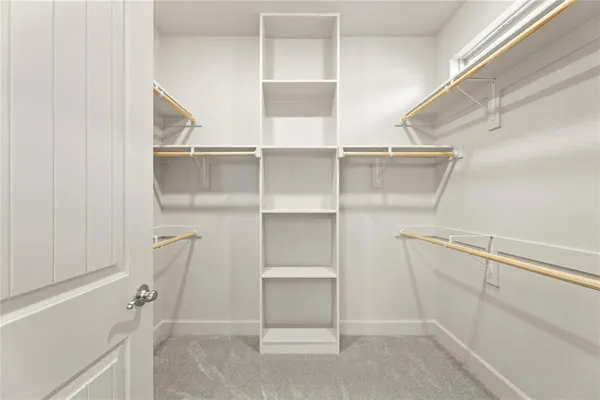 a view of walk in closet with white walls