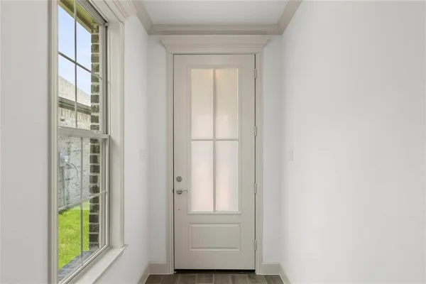 a view of front door with wooden floor