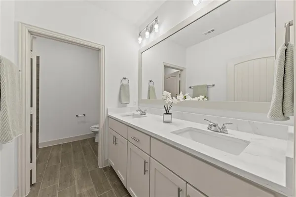 a bathroom with a double vanity sink and a mirror