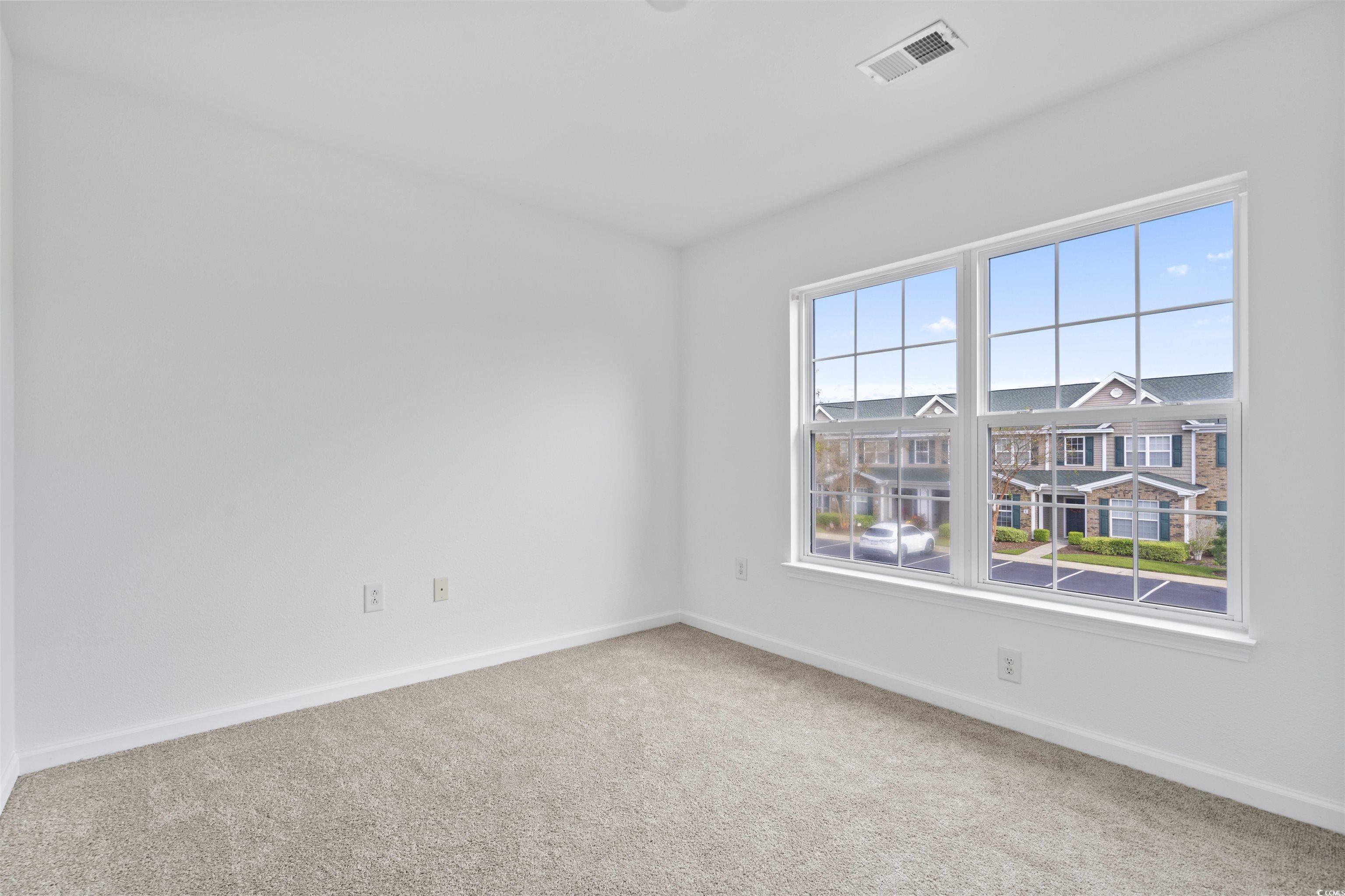 160 Chenoa Drive, Unit A Murrells Inlet, SC 29576 - Photo 28 of 37 Spare room featuring light carpet and baseboards