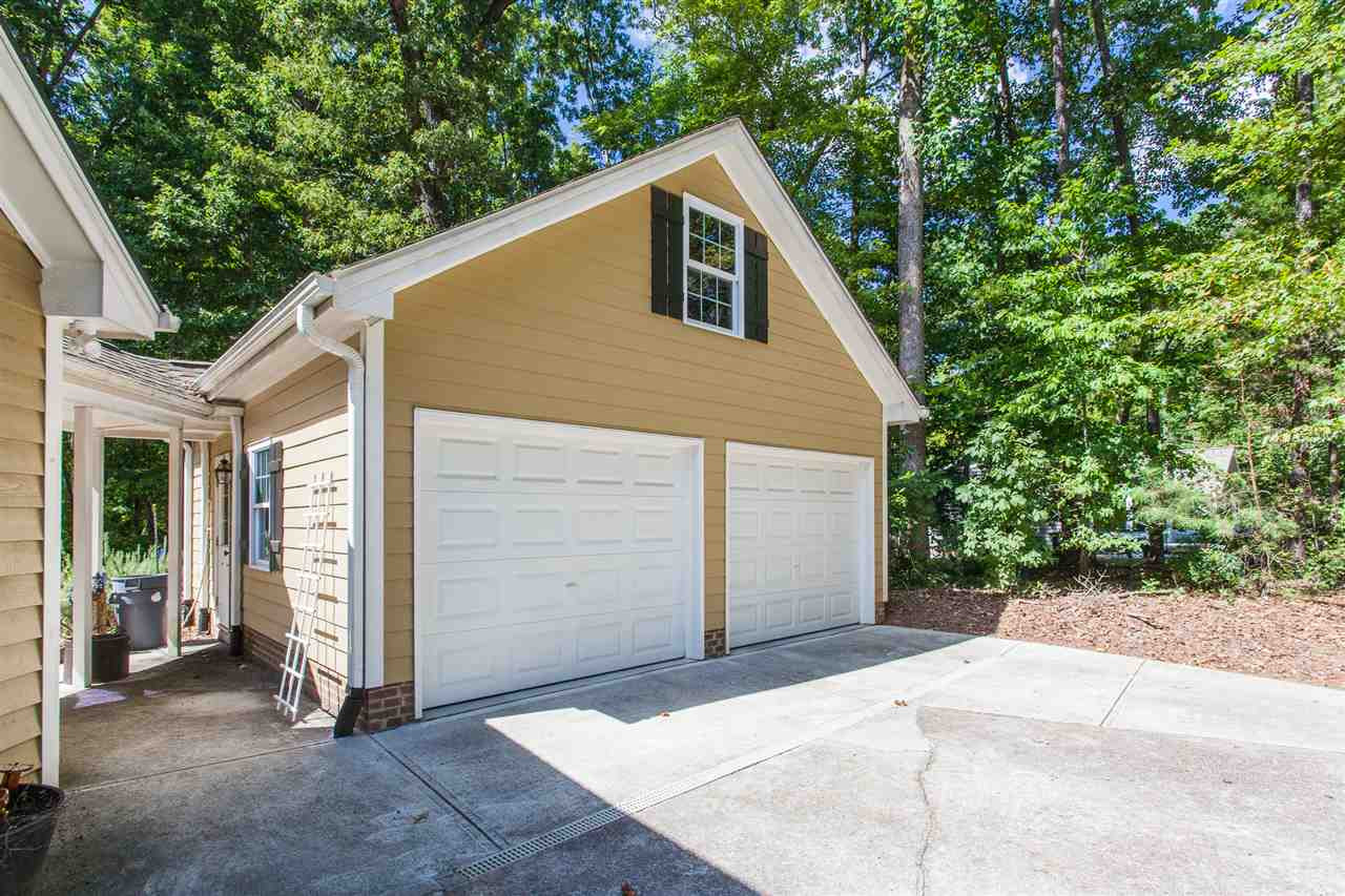 8709 Kenilworth Drive Raleigh, NC 27613 - Photo 29 of 30 Garage was added in 2013 with walk up storage area that can be finished. Fiber cement siding Garage Addition