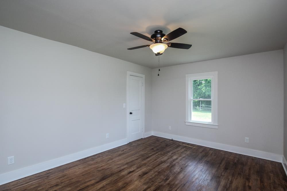 950 Owens Road Watertown, TN 37184 - Photo 18 of 30 a view of an empty room with wooden floor and a window
