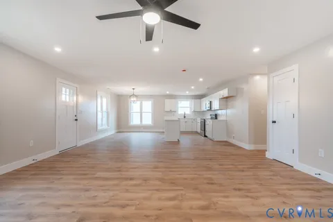 a view of empty room with wooden floor