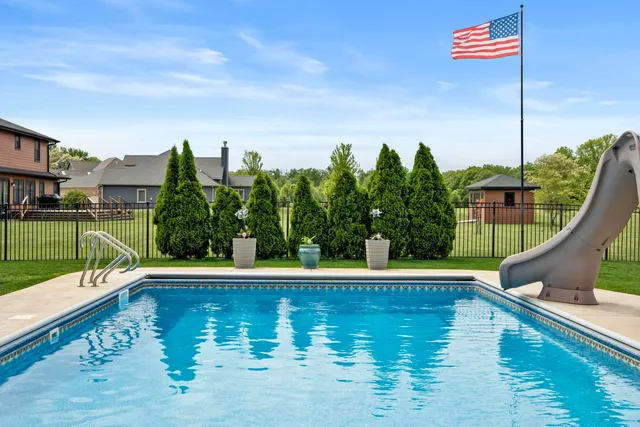 a view of a swimming pool with a lounge chair