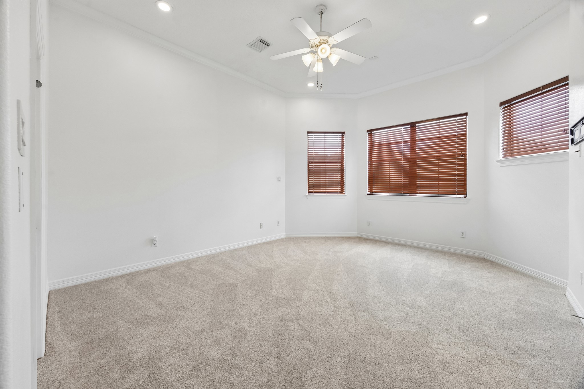 4102 Bonner View Lane Houston, TX 77007 - Photo 11 of 14 an empty room with chandelier fan and windows