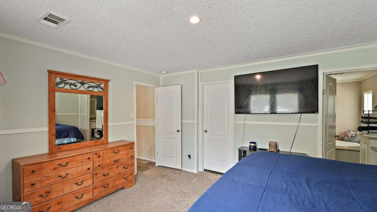 64 Sierra Road Jesup, GA 31545 - Photo 16 of 22 a living room with furniture and a flat screen tv