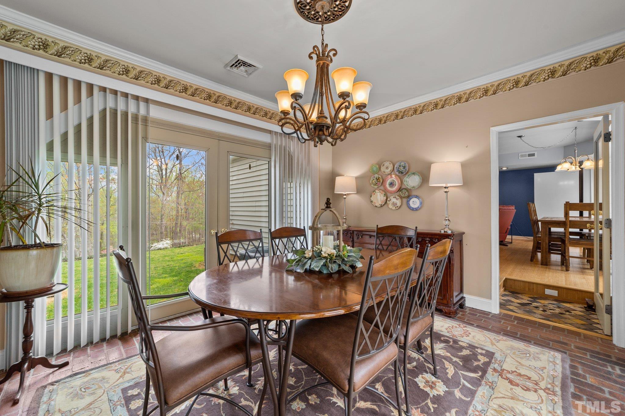 225 North Ridge Circle Roxboro, NC 27574 - Photo 14 of 33 a view of a dining room with furniture and chandelier