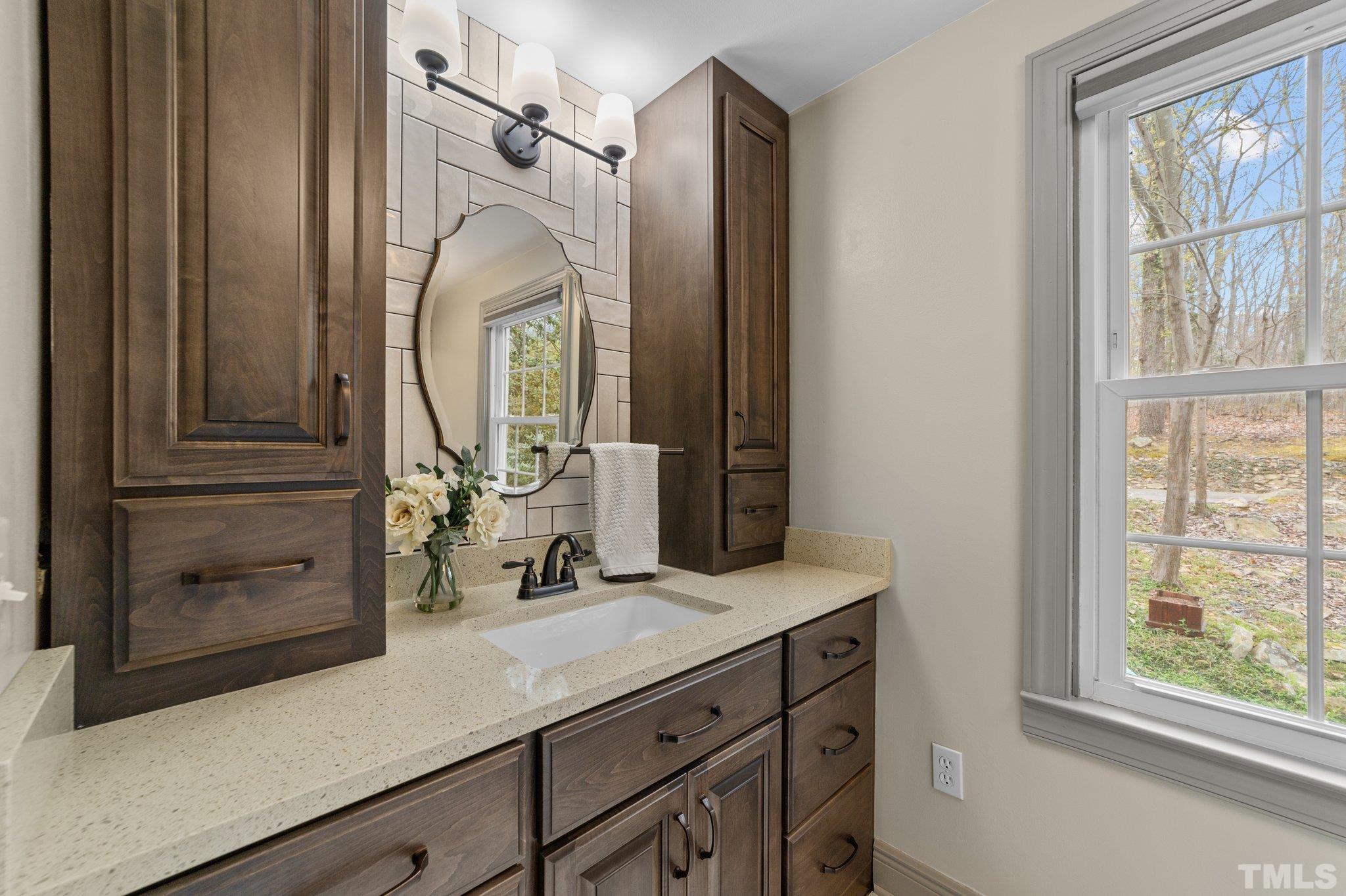 225 North Ridge Circle Roxboro, NC 27574 - Photo 22 of 33 a bathroom with a sink a vanity and a mirror