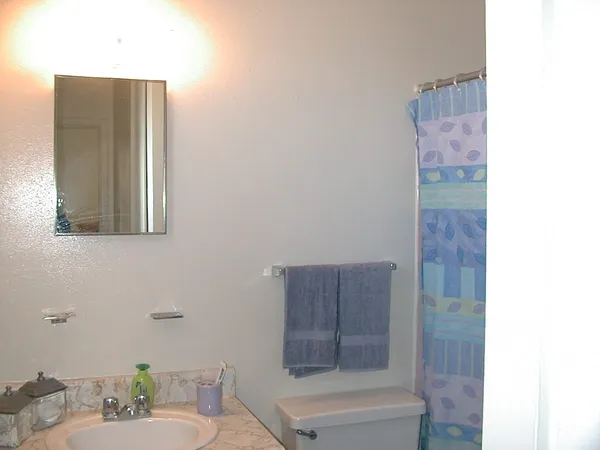 a bathroom with a toilet and shower