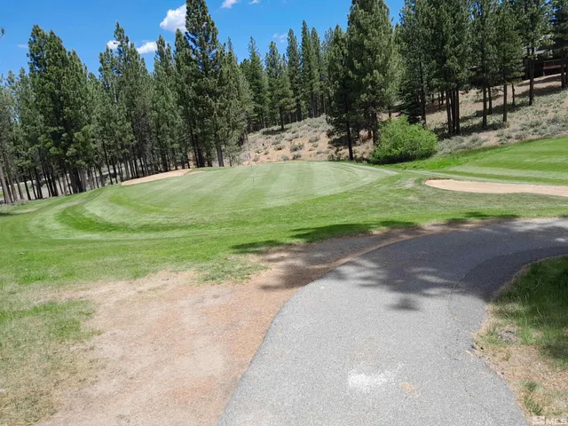 a view of a golf course with a house