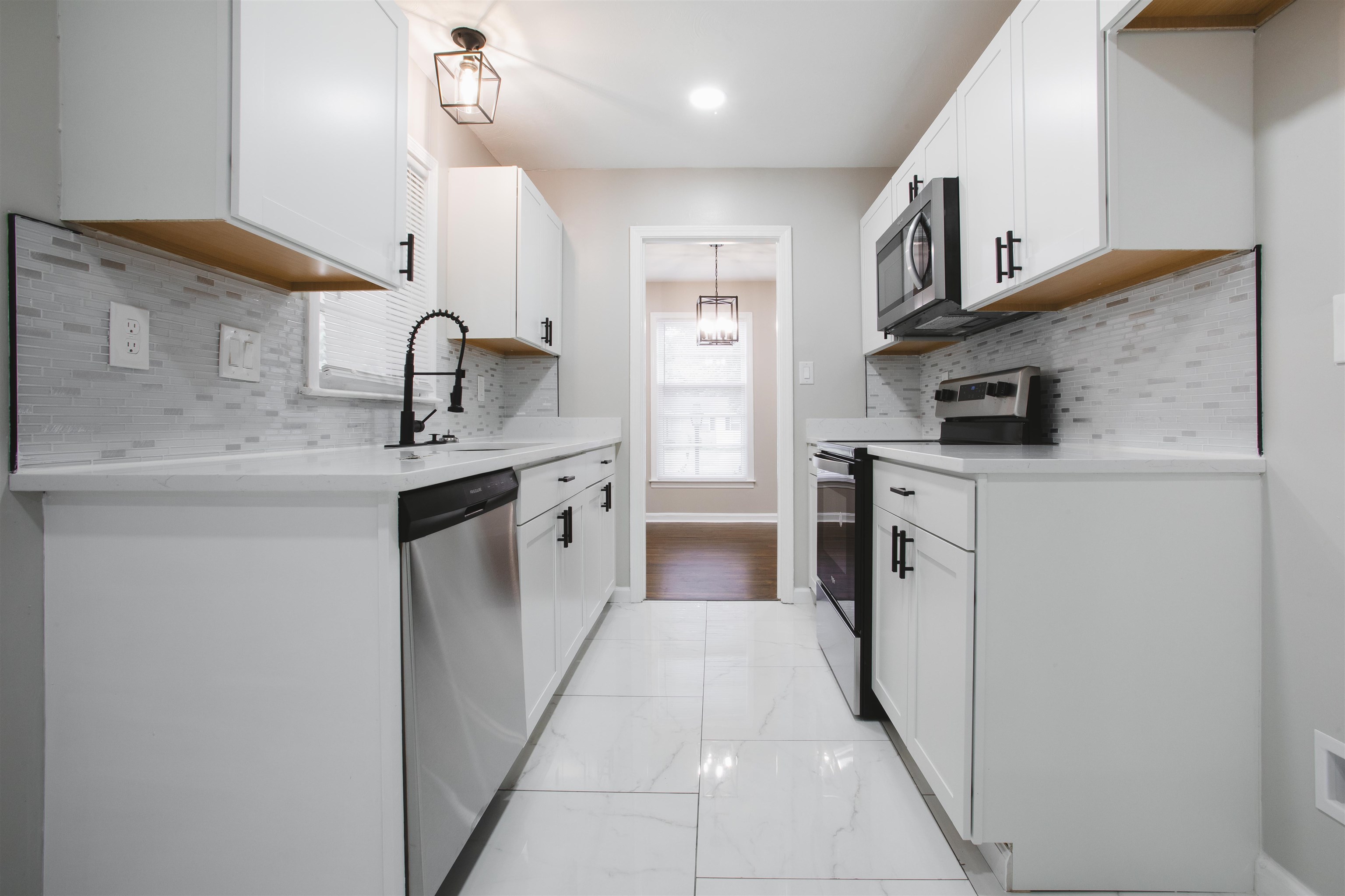 3034 Christine Road Memphis, TN 38118 - Photo 3 of 26 a kitchen with stainless steel appliances granite countertop a sink stove and refrigerator