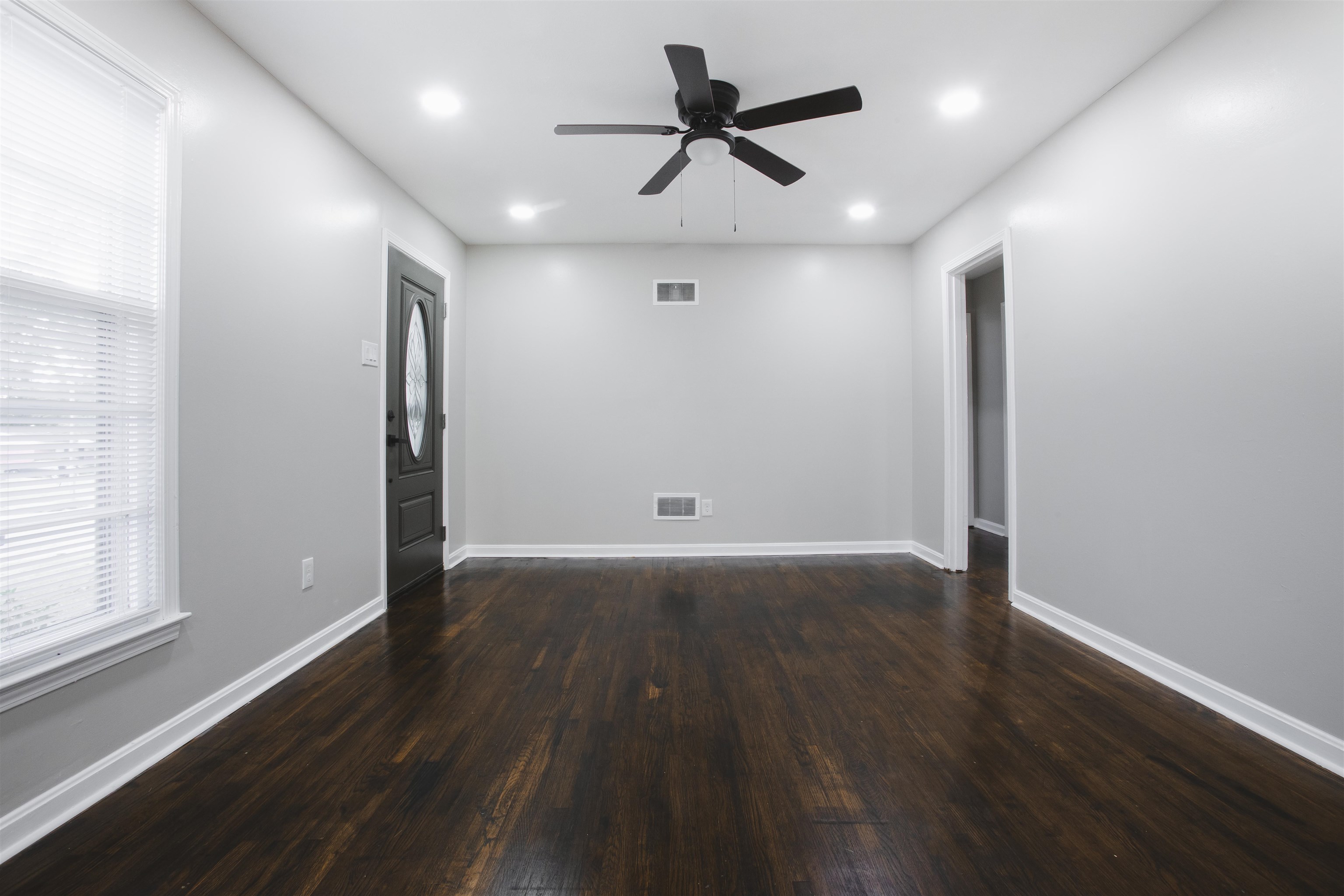 3034 Christine Road Memphis, TN 38118 - Photo 8 of 26 an empty room with wooden floor and windows