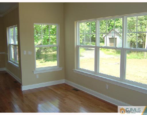 408 Old Georges Road North Brunswick, NJ 08902 - Photo 2 of 7 a view of an empty room with wooden floor and windows