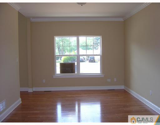 408 Old Georges Road North Brunswick, NJ 08902 - Photo 6 of 7 a view of empty room with wooden floor and fan