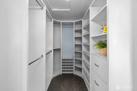 a view of walk in closet with empty racks