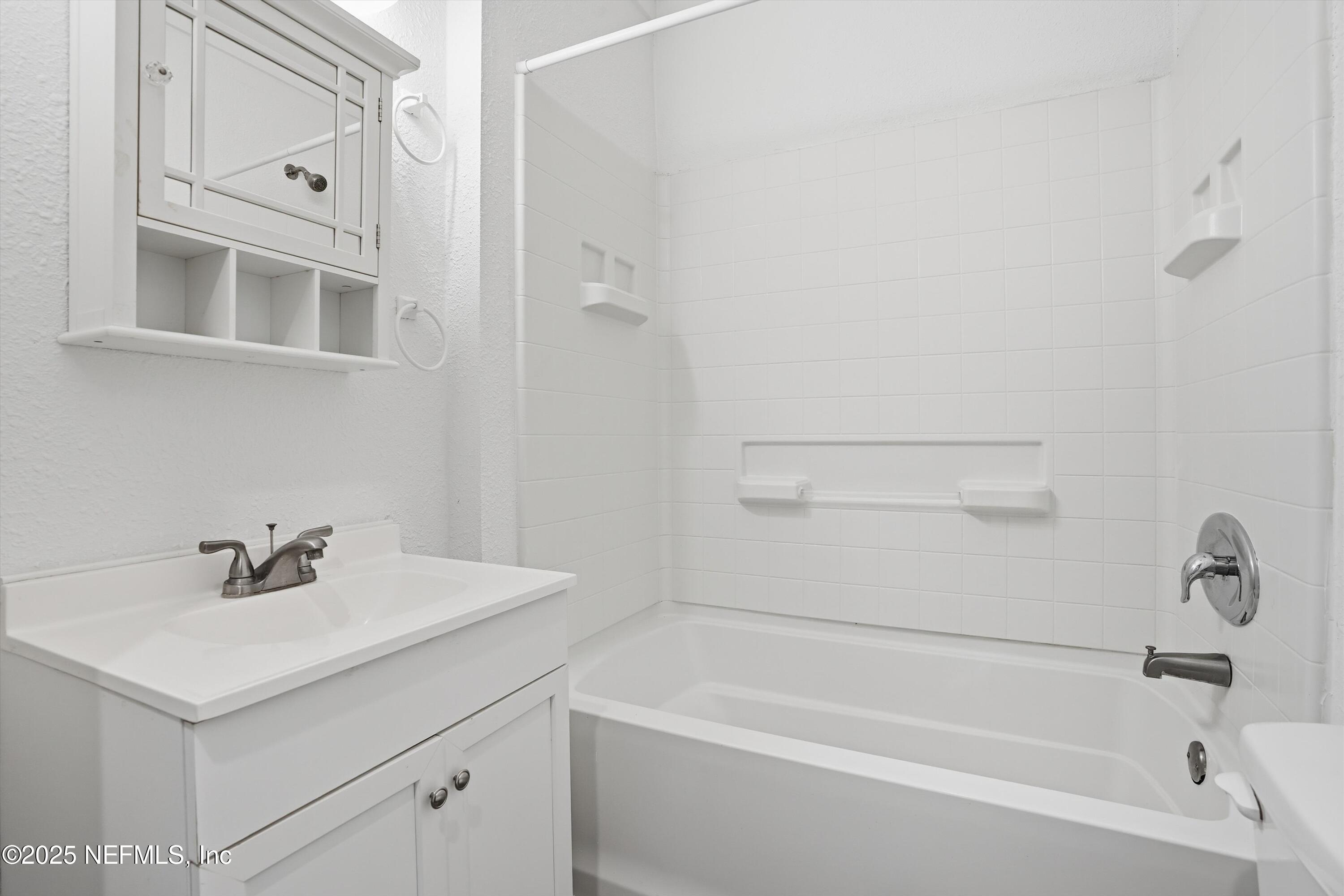 911 Phillips Street Jacksonville, FL 32207 - Photo 16 of 36 a white bath tub sitting next to a white sink