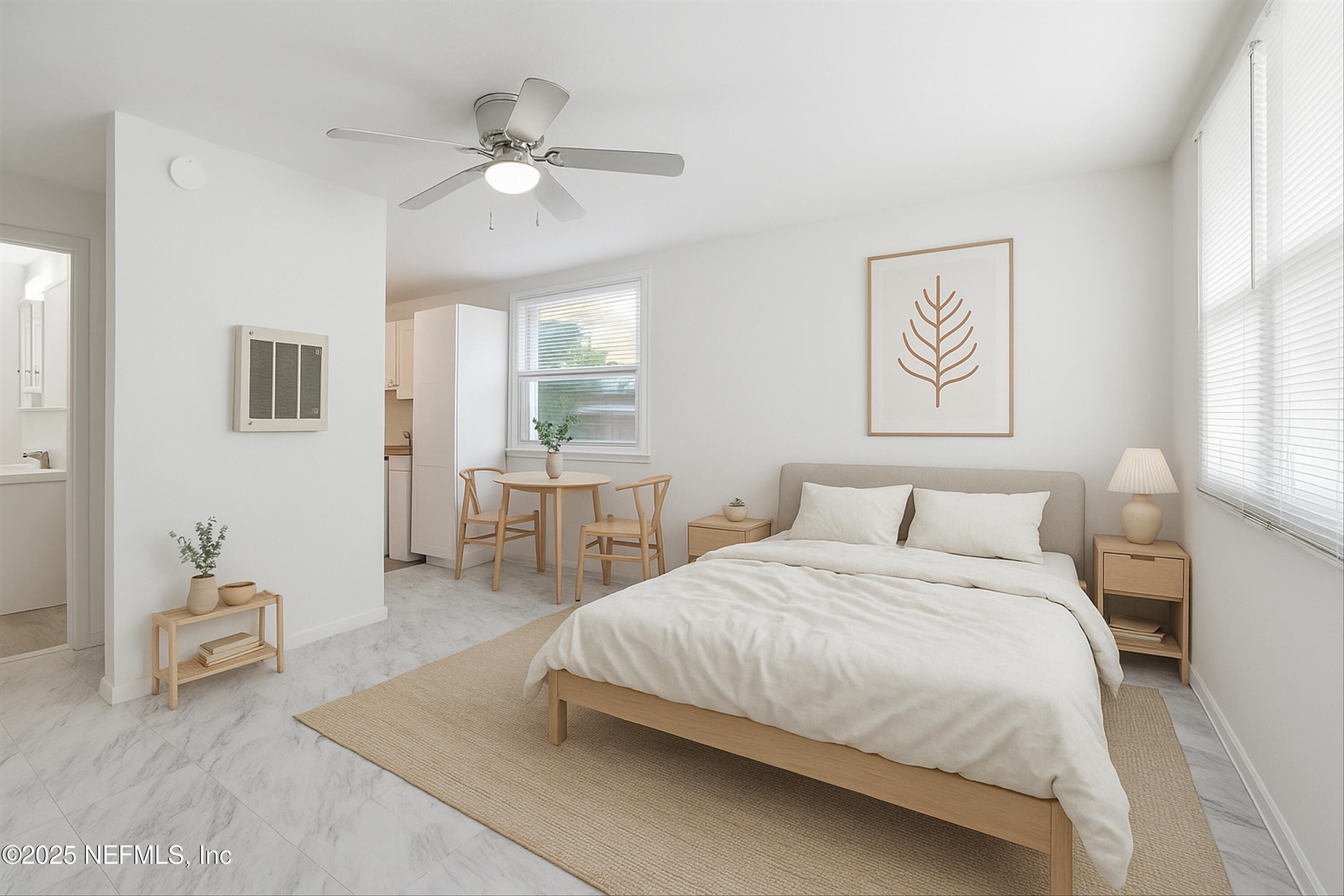 911 Phillips Street Jacksonville, FL 32207 - Photo 18 of 36 a bedroom with a bed and a chandelier