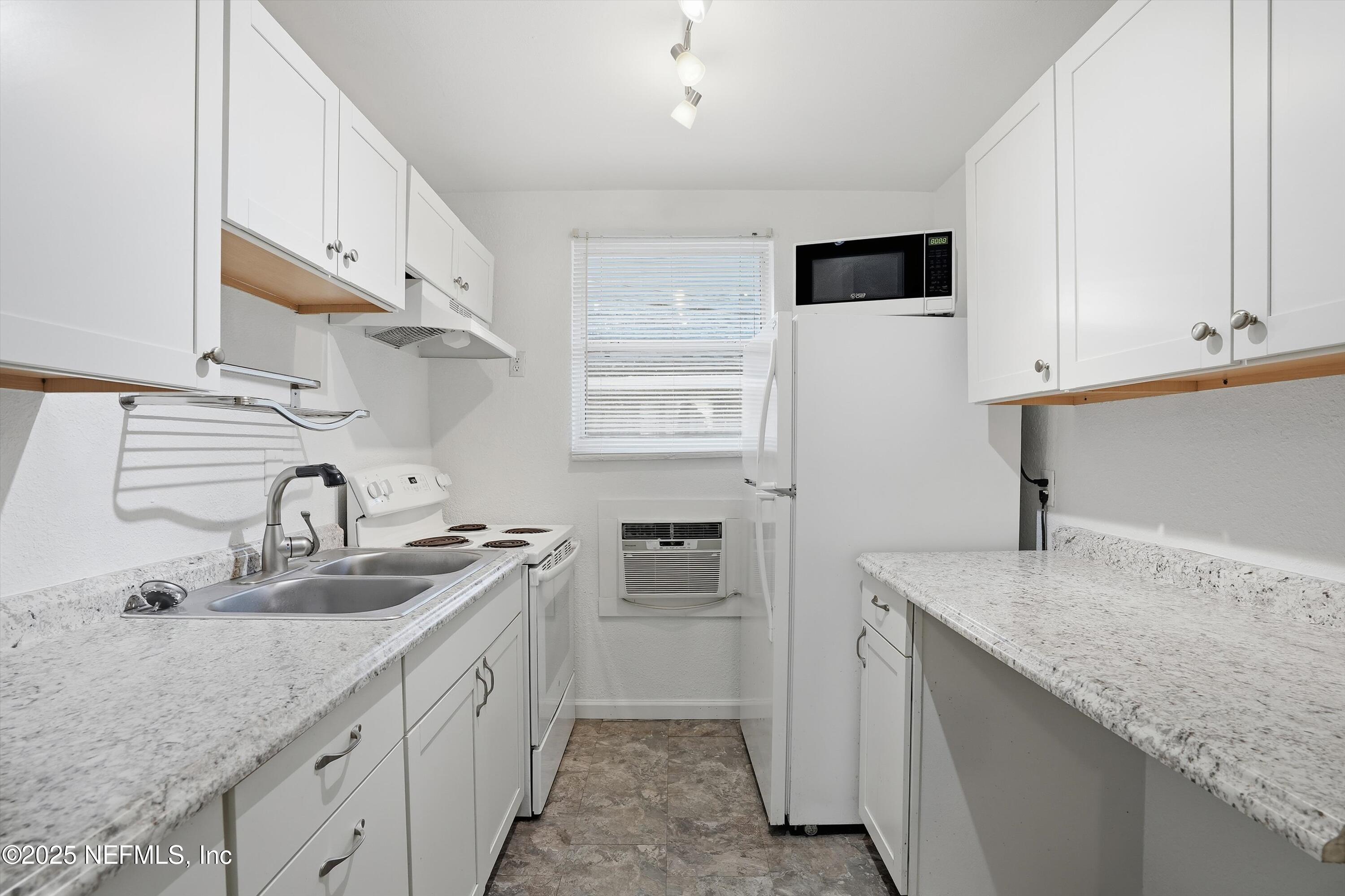911 Phillips Street Jacksonville, FL 32207 - Photo 23 of 36 a kitchen with stainless steel appliances granite countertop a sink stove and refrigerator