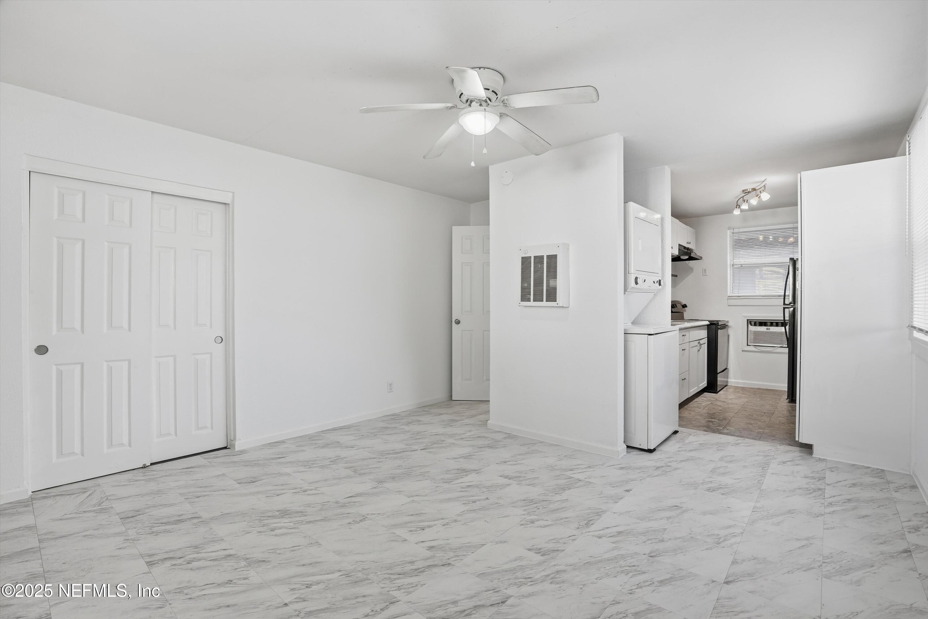 911 Phillips Street Jacksonville, FL 32207 - Photo 26 of 36 a view of a livingroom with a chandelier fan and kitchen view