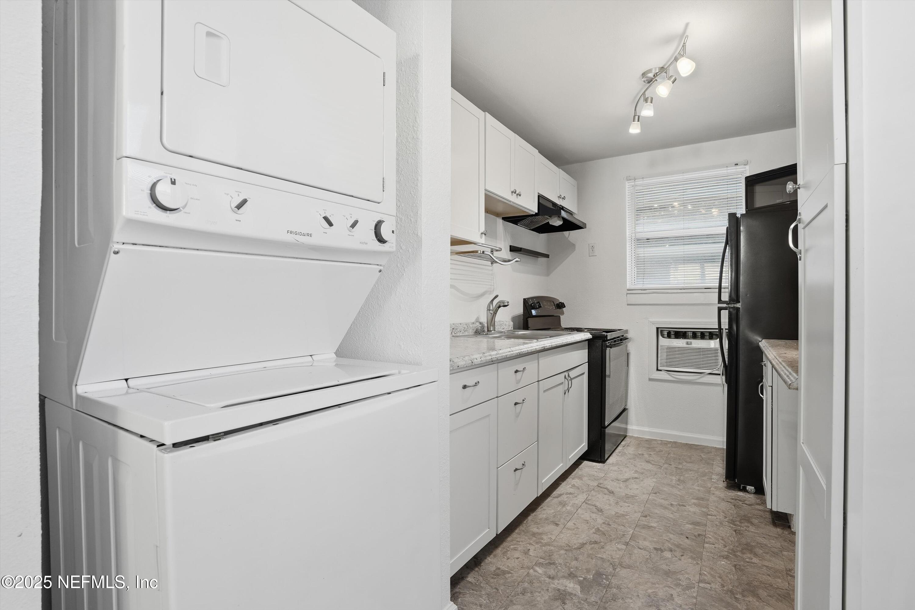 911 Phillips Street Jacksonville, FL 32207 - Photo 29 of 36 a kitchen with cabinets and a refrigerator